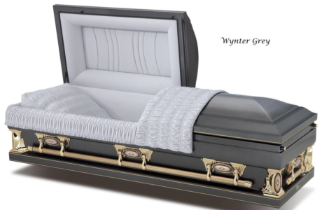 Black and gold open casket with white satin interior and gray lining