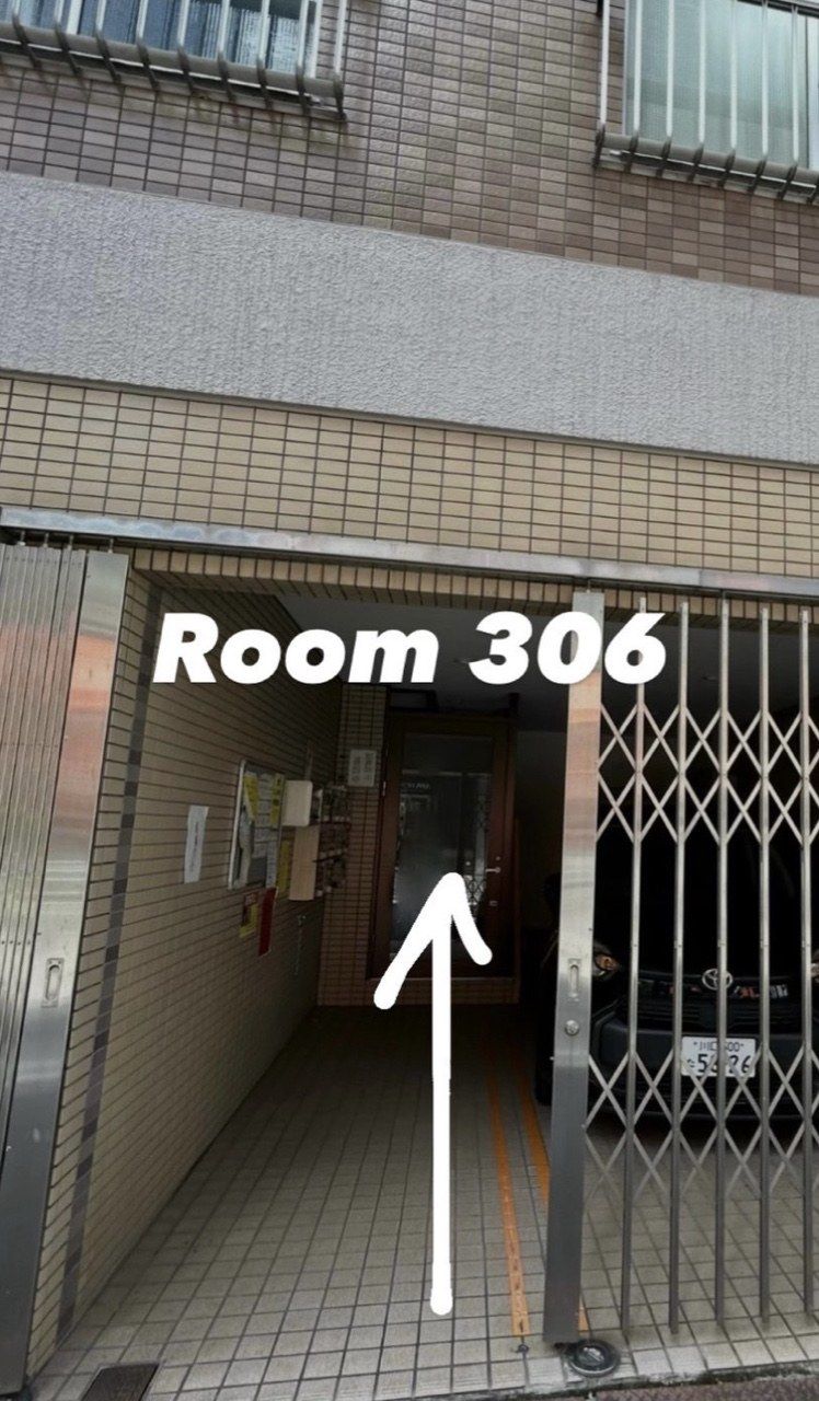 The outside of the Funaki Building, with the entrance and the Room 306 arrow