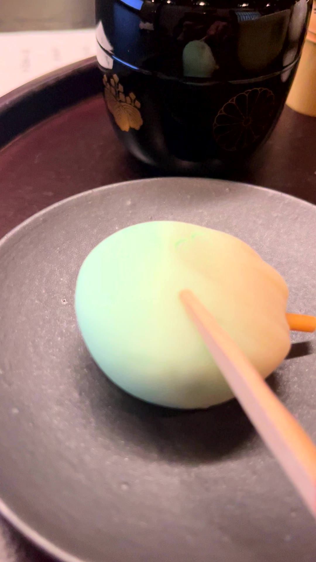 A seasonal wagashi sweet with a bamboo knife