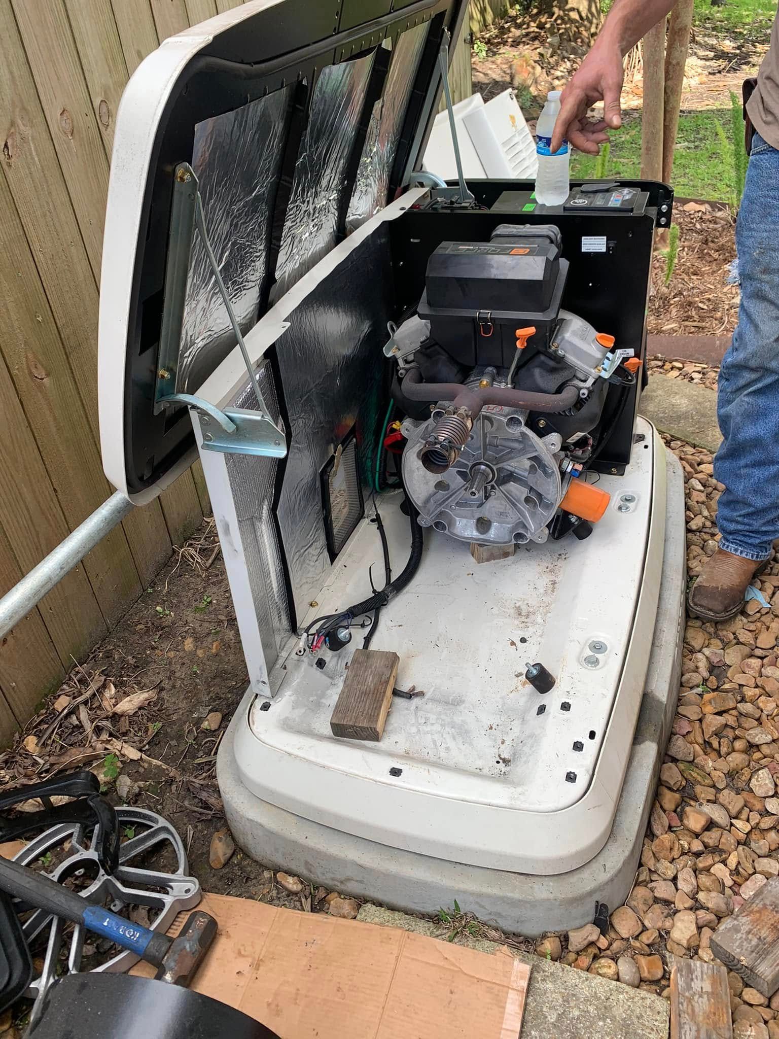 Open white utility trailer with a small engine and tools inside, outdoors on gravel.