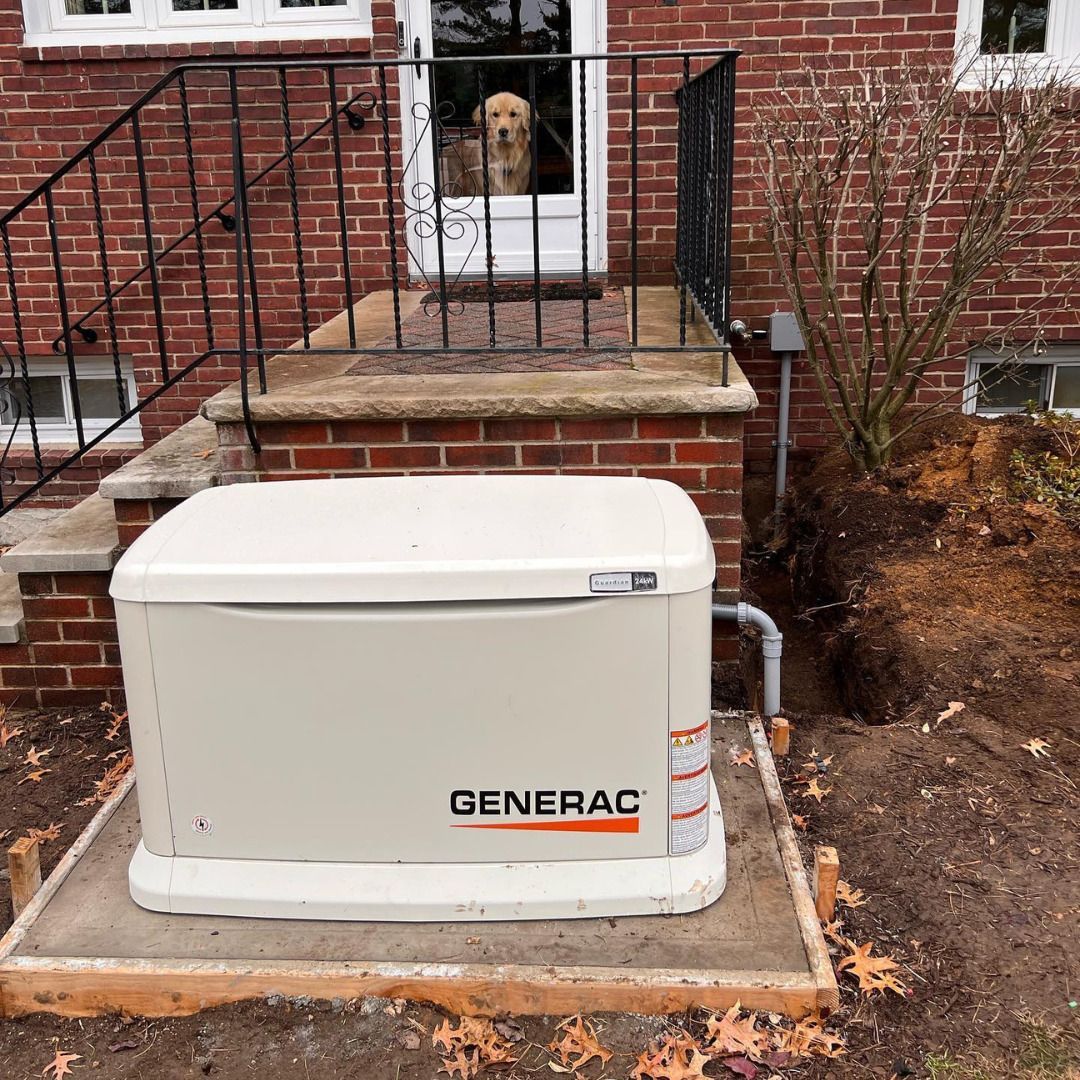 White Generac generator on a concrete pad beside a brick house, with a dog in the window above.