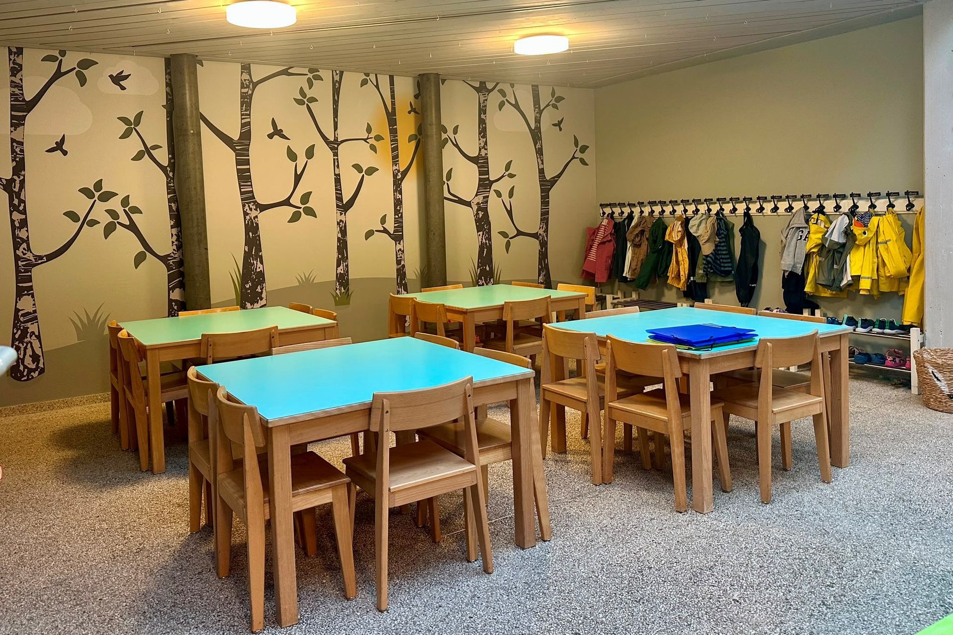 A room with tables and chairs and a green ceiling