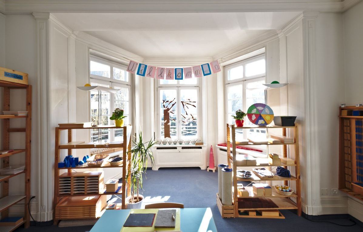 A room with a lot of shelves and a table