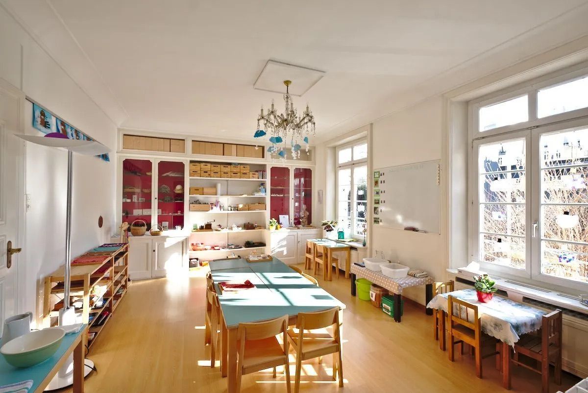 A large room with tables and chairs in it