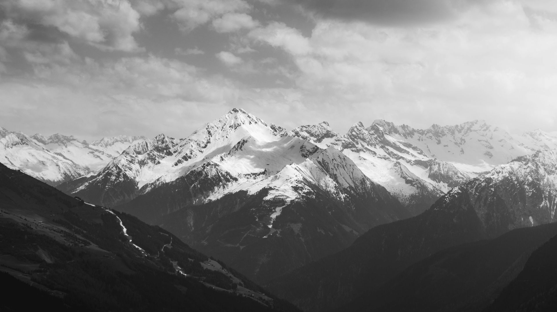 A black and white photo of a snowy mountain range