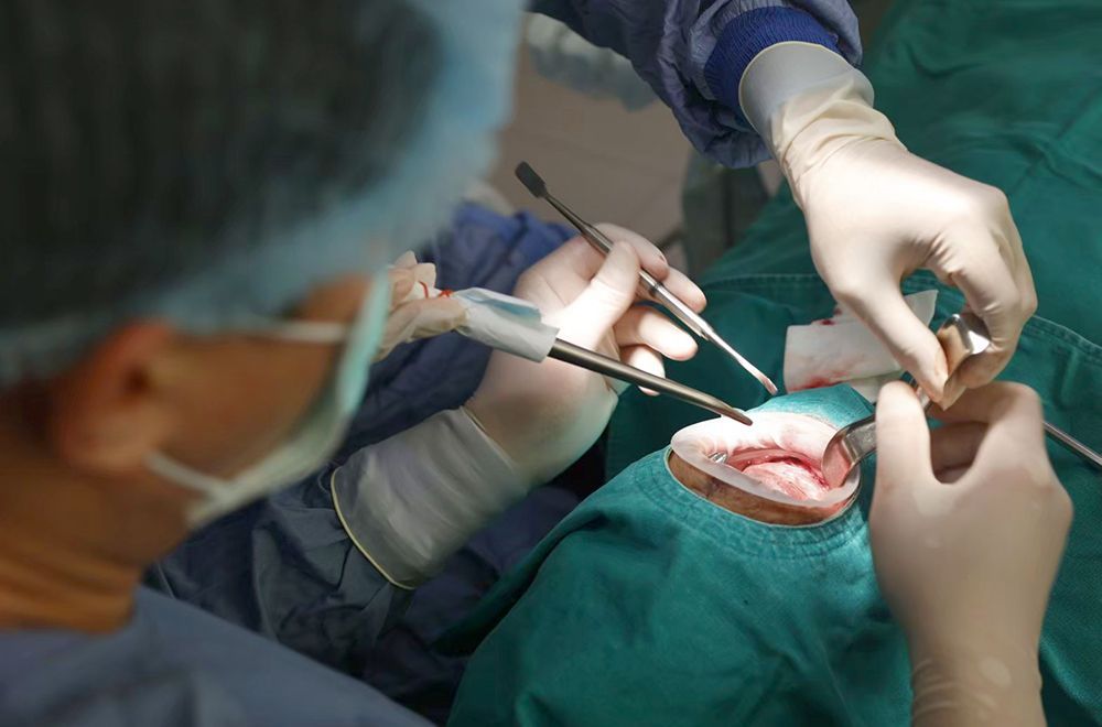 A surgeon is operating on a patient in an operating room