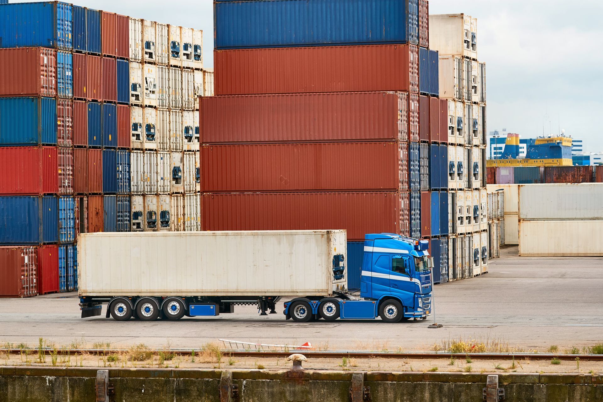 Semi-truck in an intermodal shipping hub.