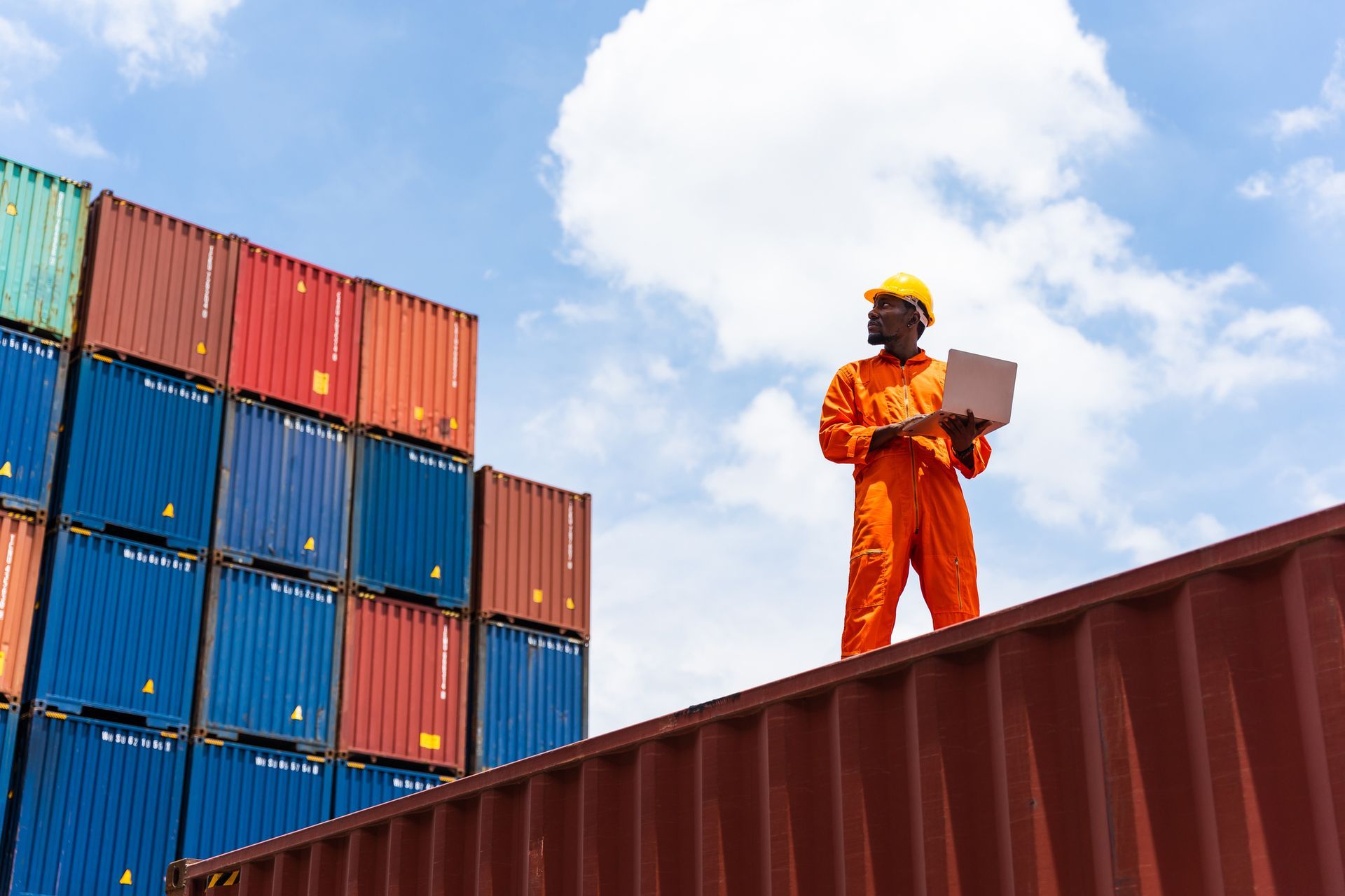 Worker using a laptop working in the commercial dock.