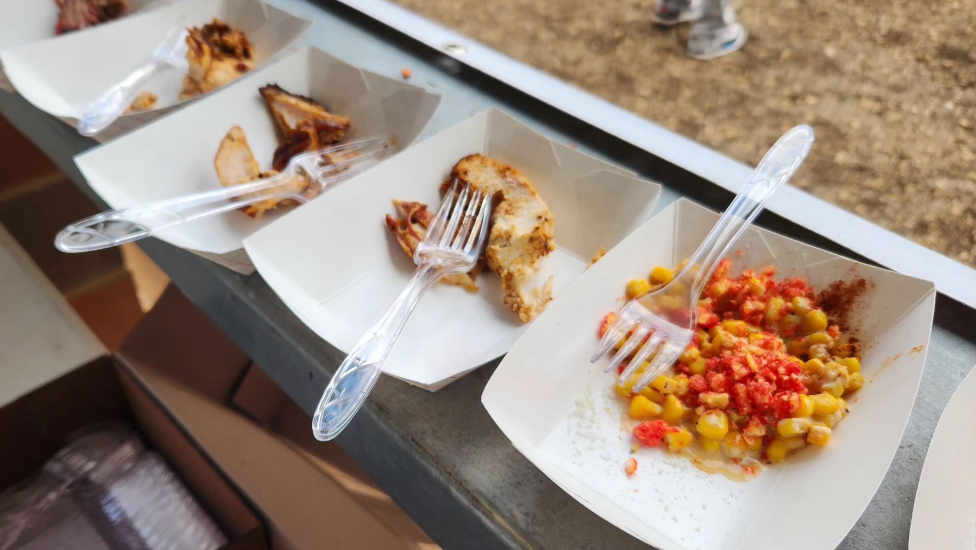 Plates of samples on a table, featuring a corn dish at the San Antonio Engineering BBQ Cook-off.