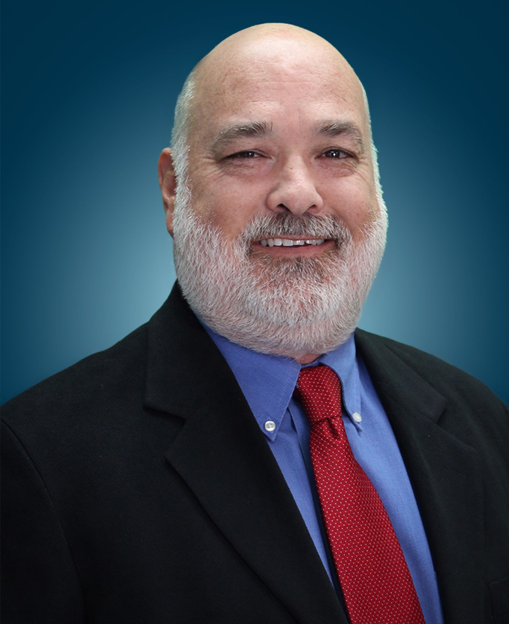 Headshot of Abiel R. Hinojosa smiling in a black suit against a blue gradient background.