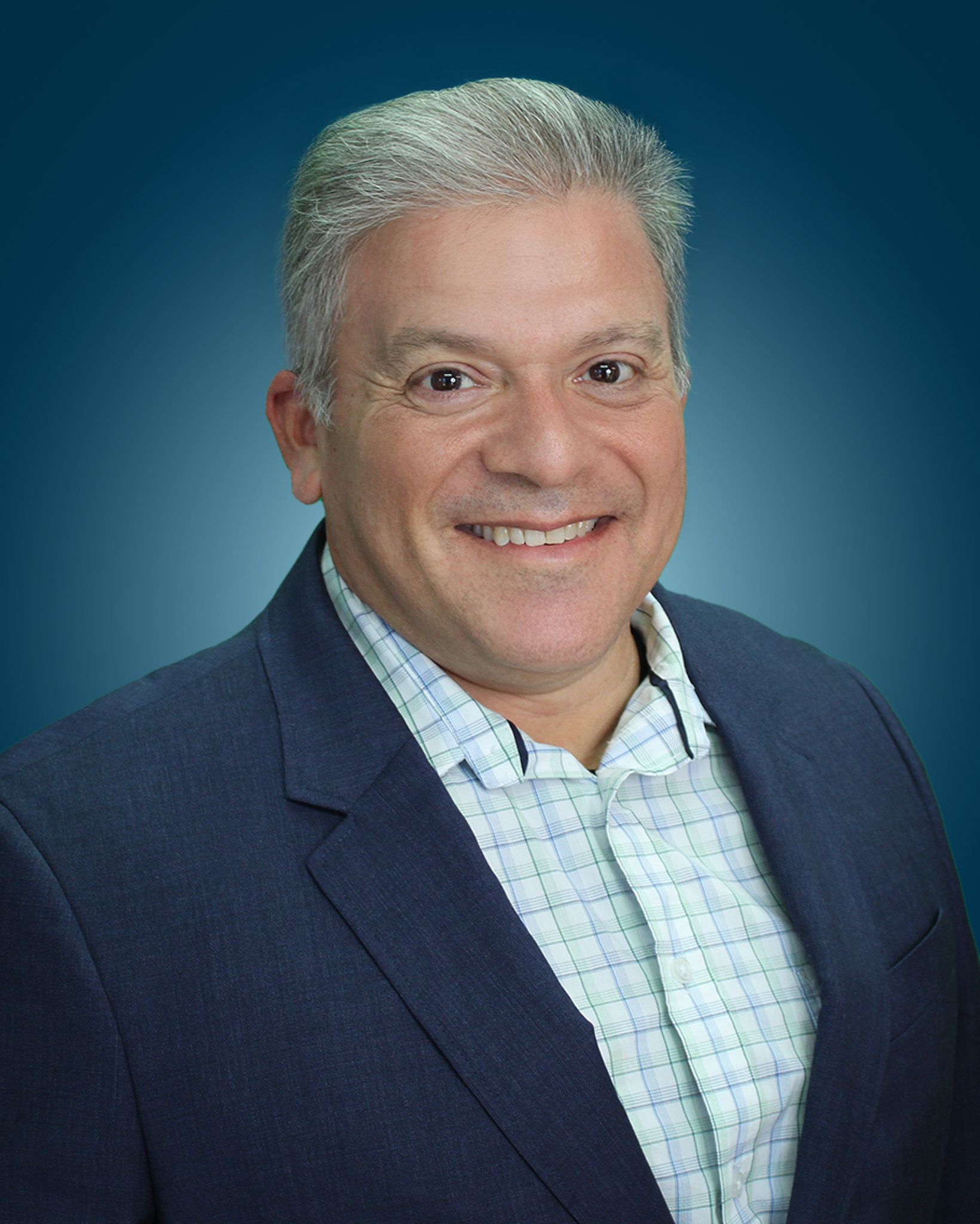 Headshot of Damien J. Herrera, P.E. against a blue gradient background.