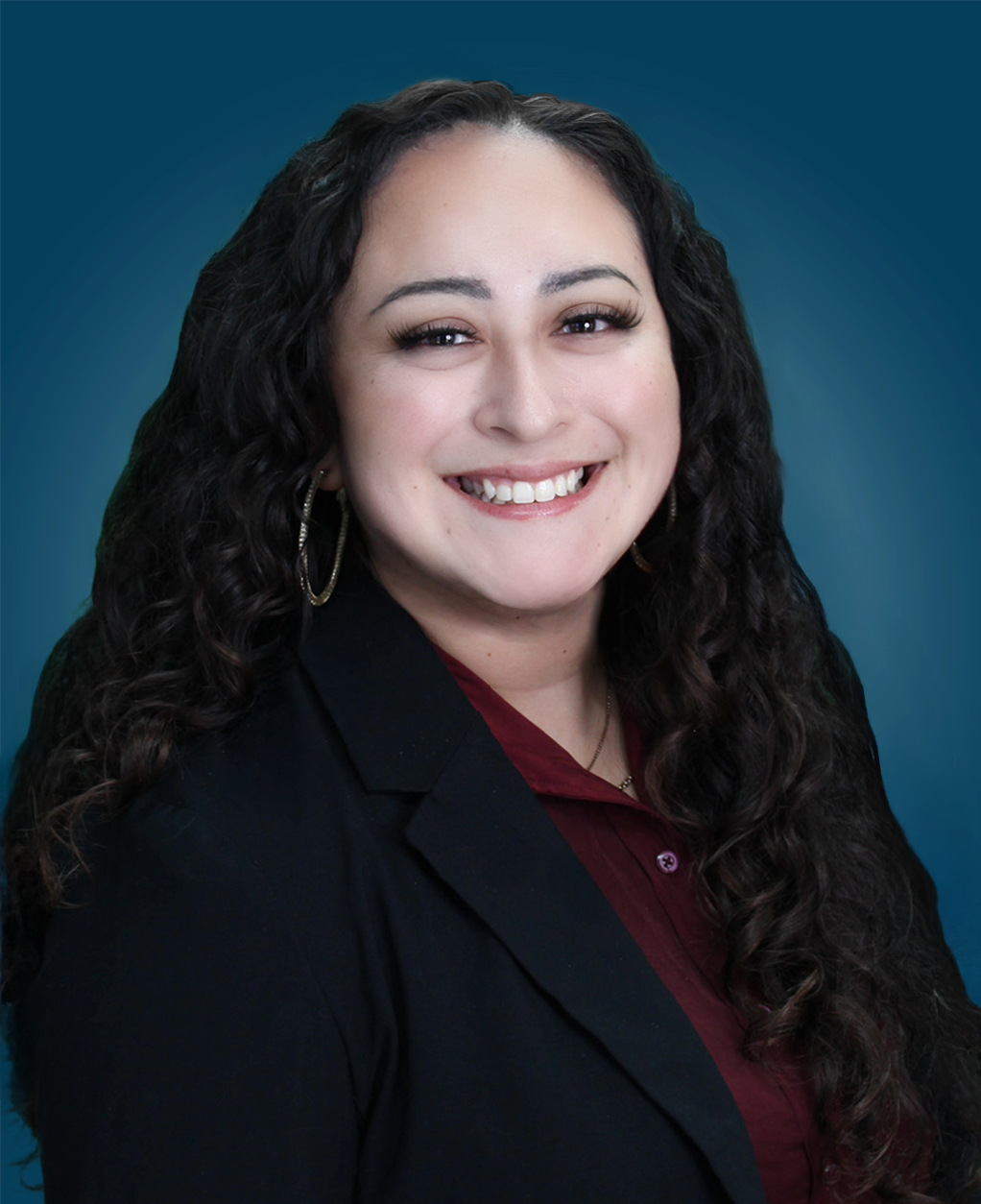 Headshot of Gabriella Gonzales against a blue gradient background.