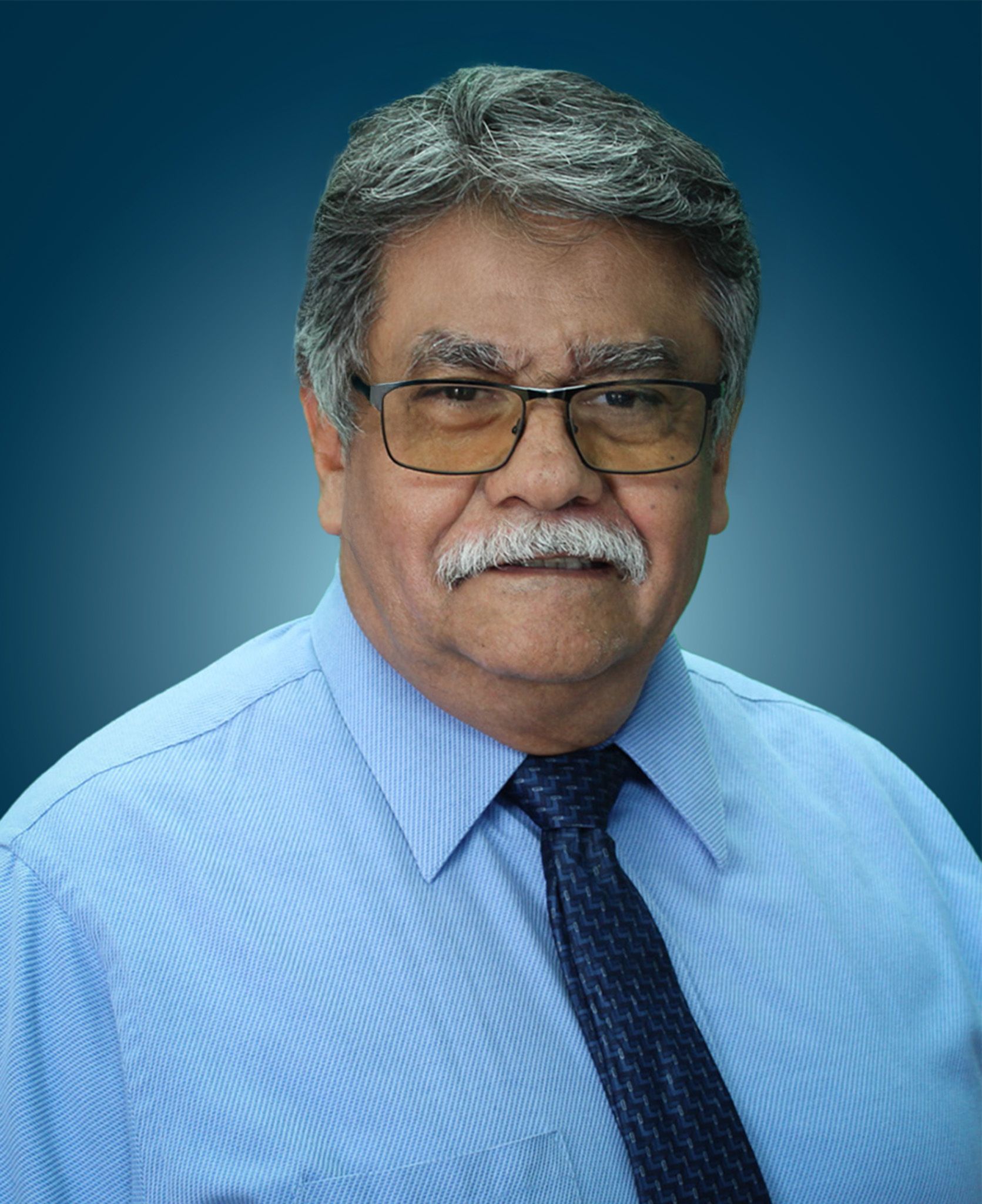 Headshot of Jesse Gutierrez against a blue gradient background.
