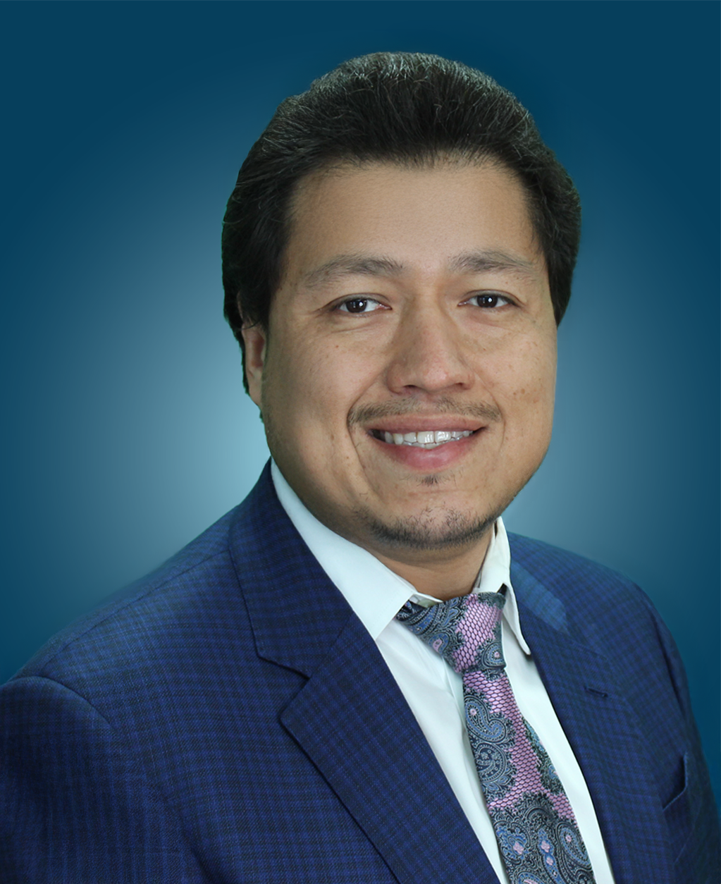 Headshot of Mario Morales against a blue gradient background.