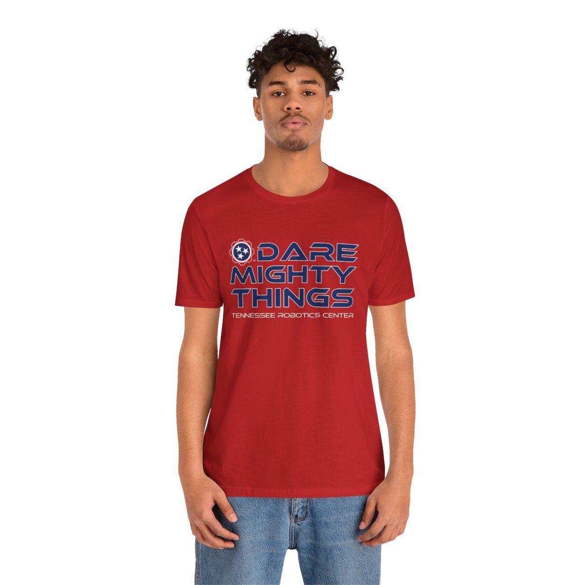 Red T-shirt with “DARE MIGHTY THINGS” text in blue and white logo on chest