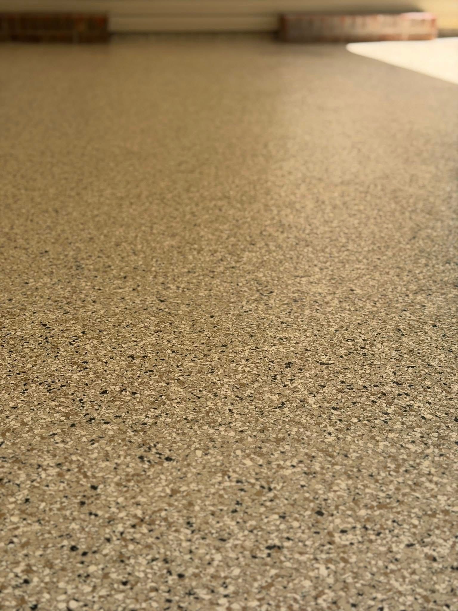 Close-up of a speckled beige countertop with a blurred kitchen background