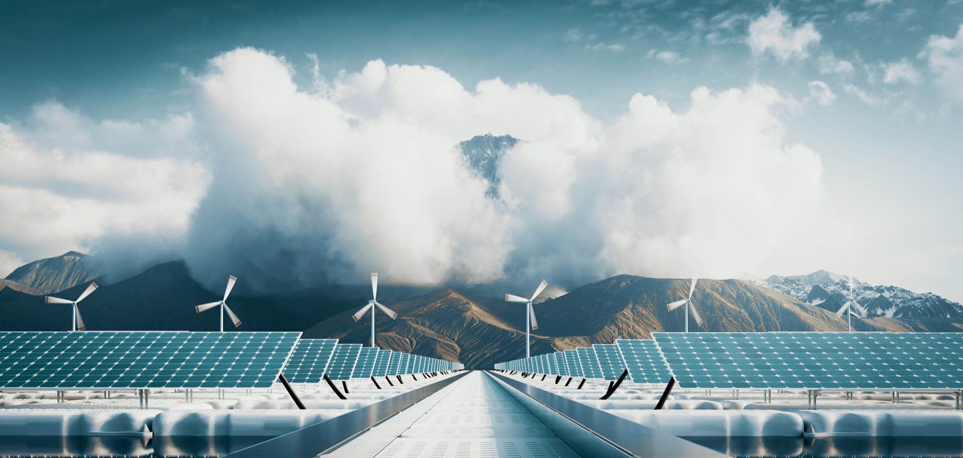 Solar panels and wind turbines with mountains in the background, promoting renewable energy.