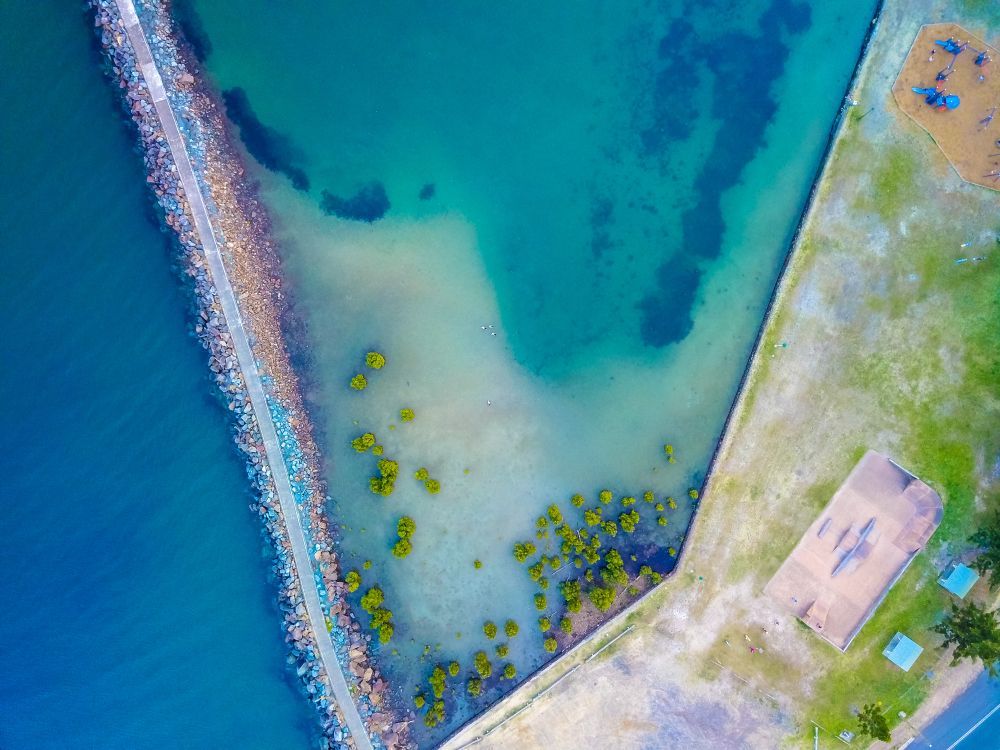 An Aerial View Of A Body Of Water Next To A Beach — Port Macquarie Locksmiths In Harrington, NSW