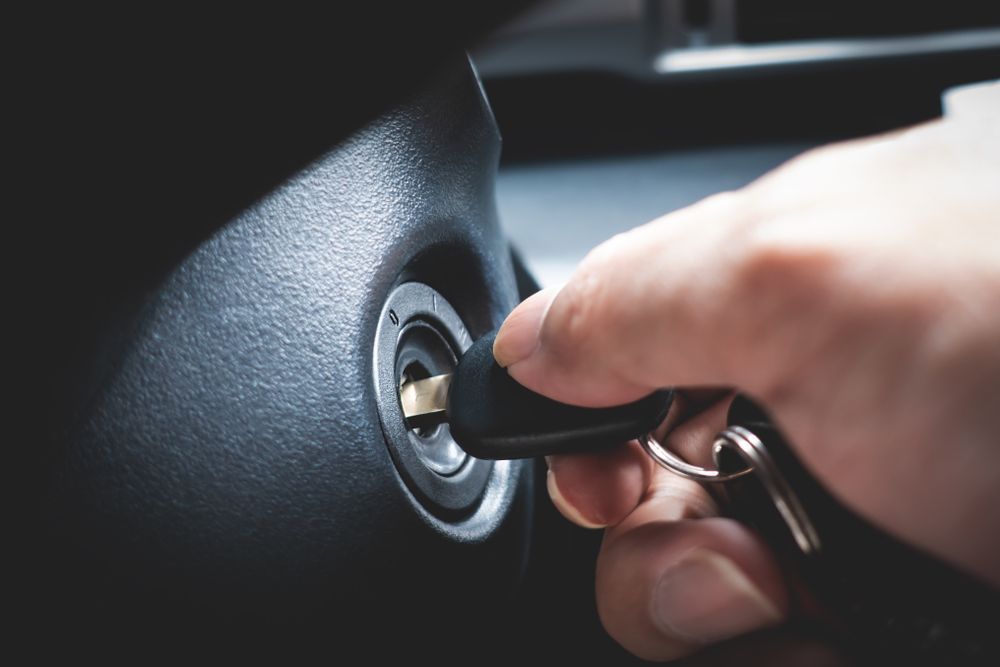 A Person Is Holding A Car Key In Their Hand And Starting A Car — Port Macquarie Locksmiths In Kempsey, NSW