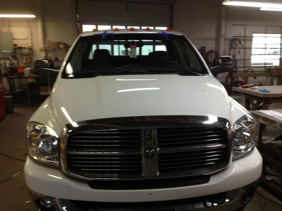 White pickup truck parked inside an auto shop garage