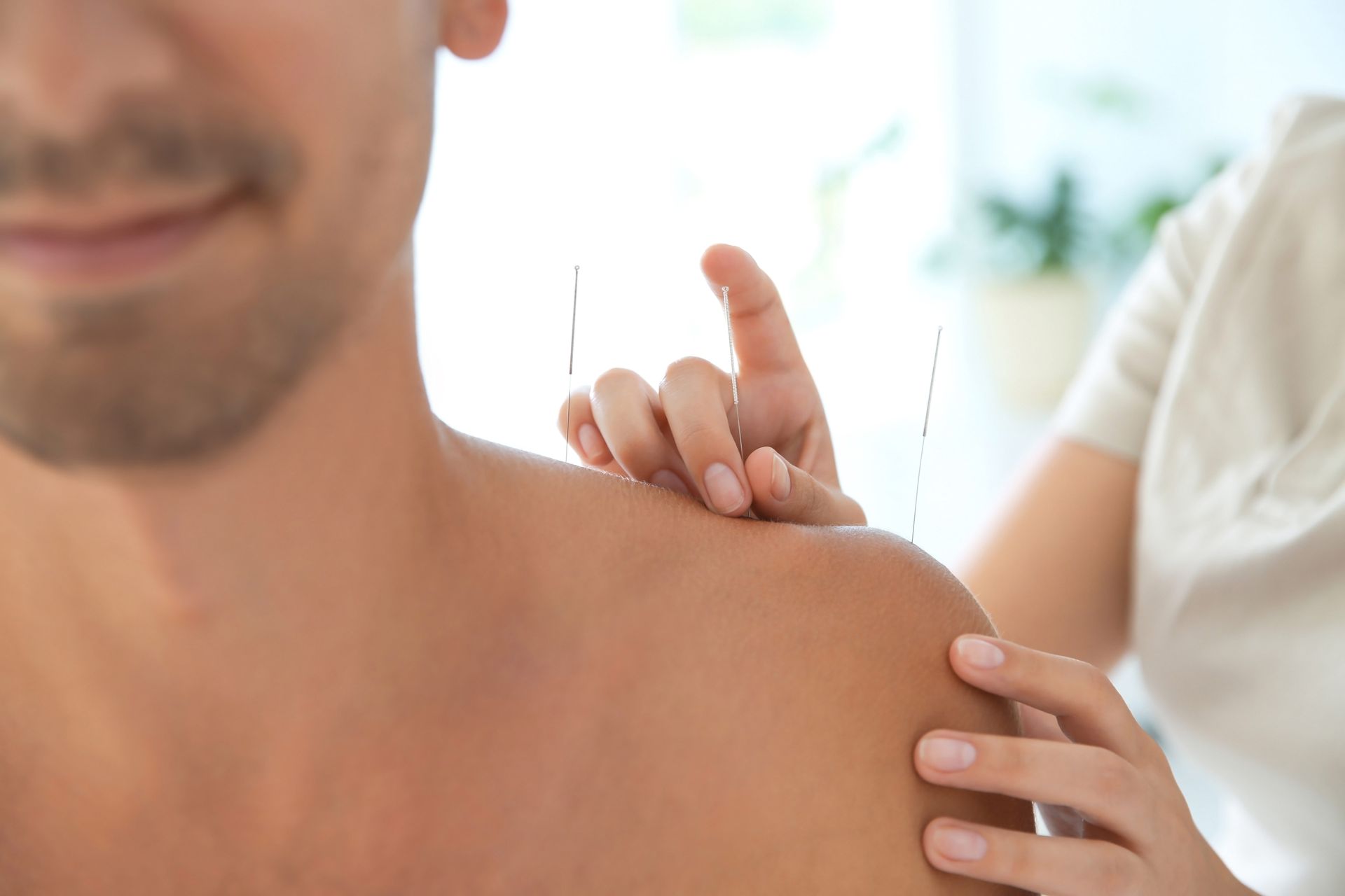 Person receiving a shoulder massage indoors