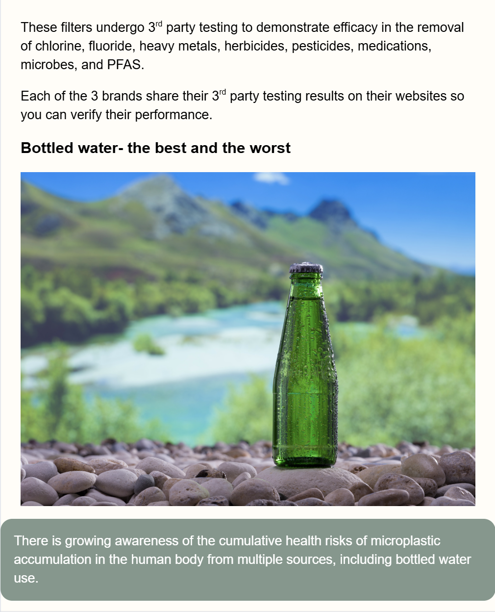 Green glass bottle on river stones with mountain lake and hills in the background