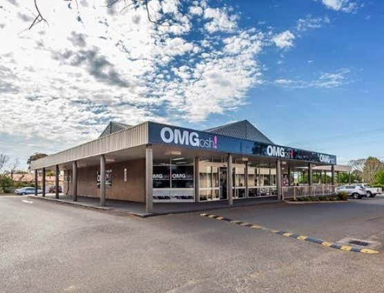 A large building with a blue sign that says omg on it.