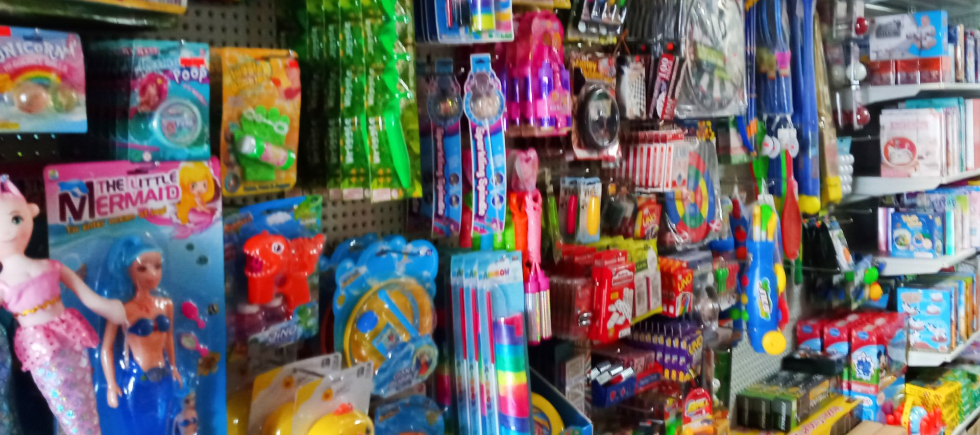 A shelf filled with lots of colorful toys in a store.