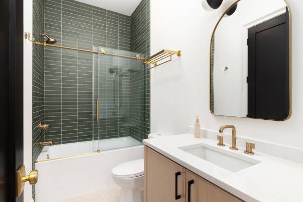 A bathroom with a sink, toilet, shower and mirror — San Leandro, CA — Mission Flooring and Countertop Design