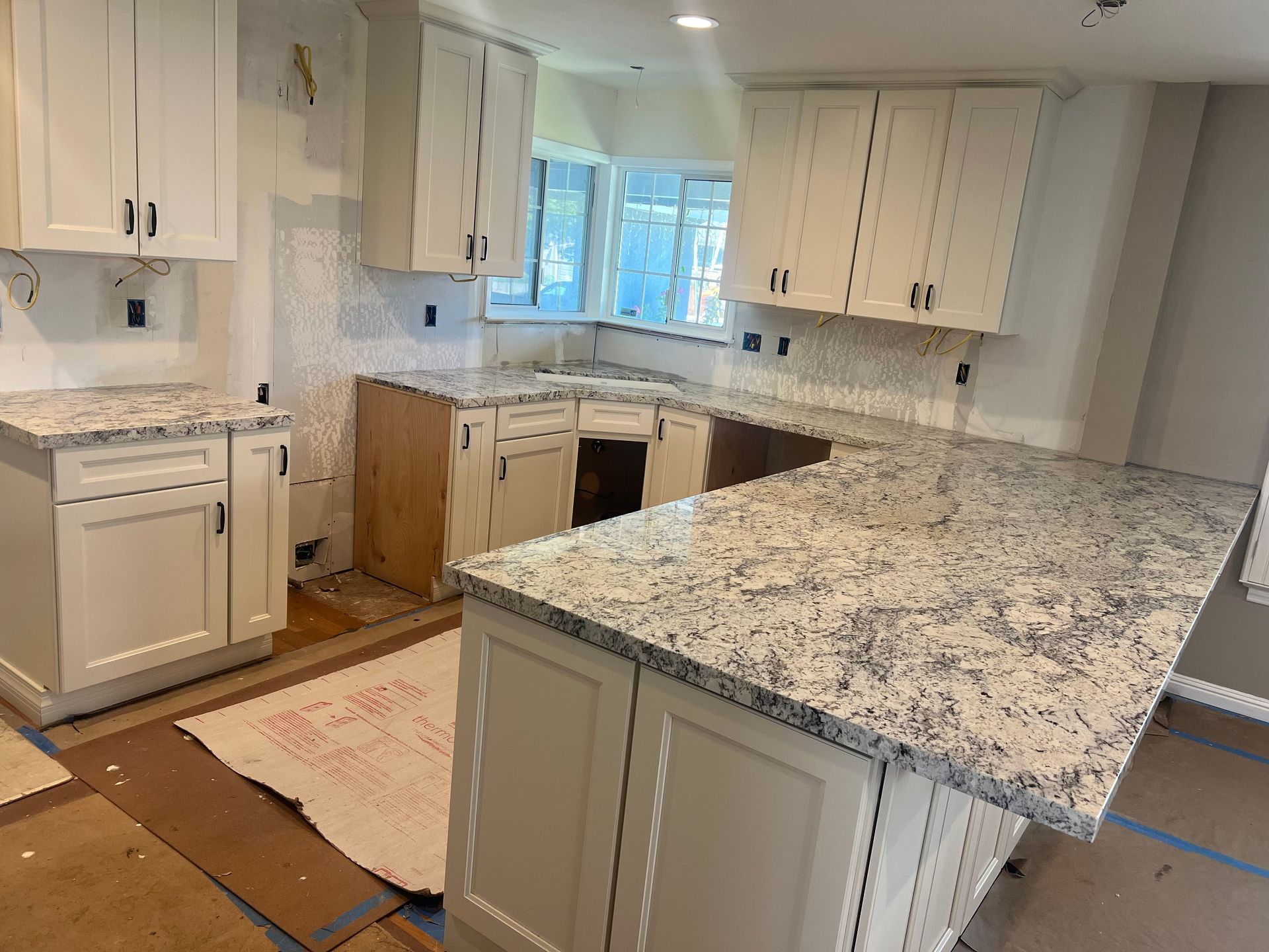 A kitchen with stainless steel appliances and white counter tops — San Leandro, CA — Mission Flooring and Countertop Design