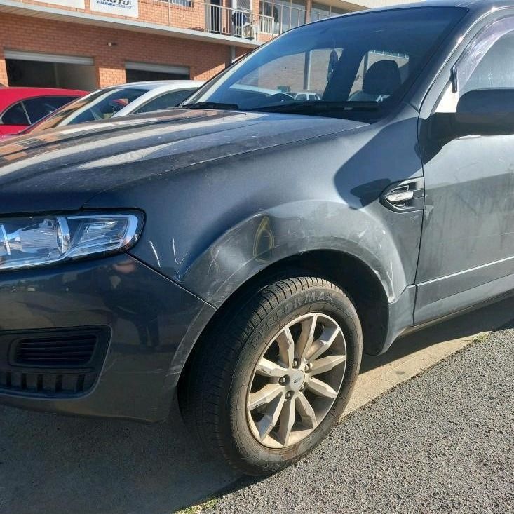 A Car With a Dented Front Fender Parked Outdoors — Moto Bodyworks in Fyshwick, ACT