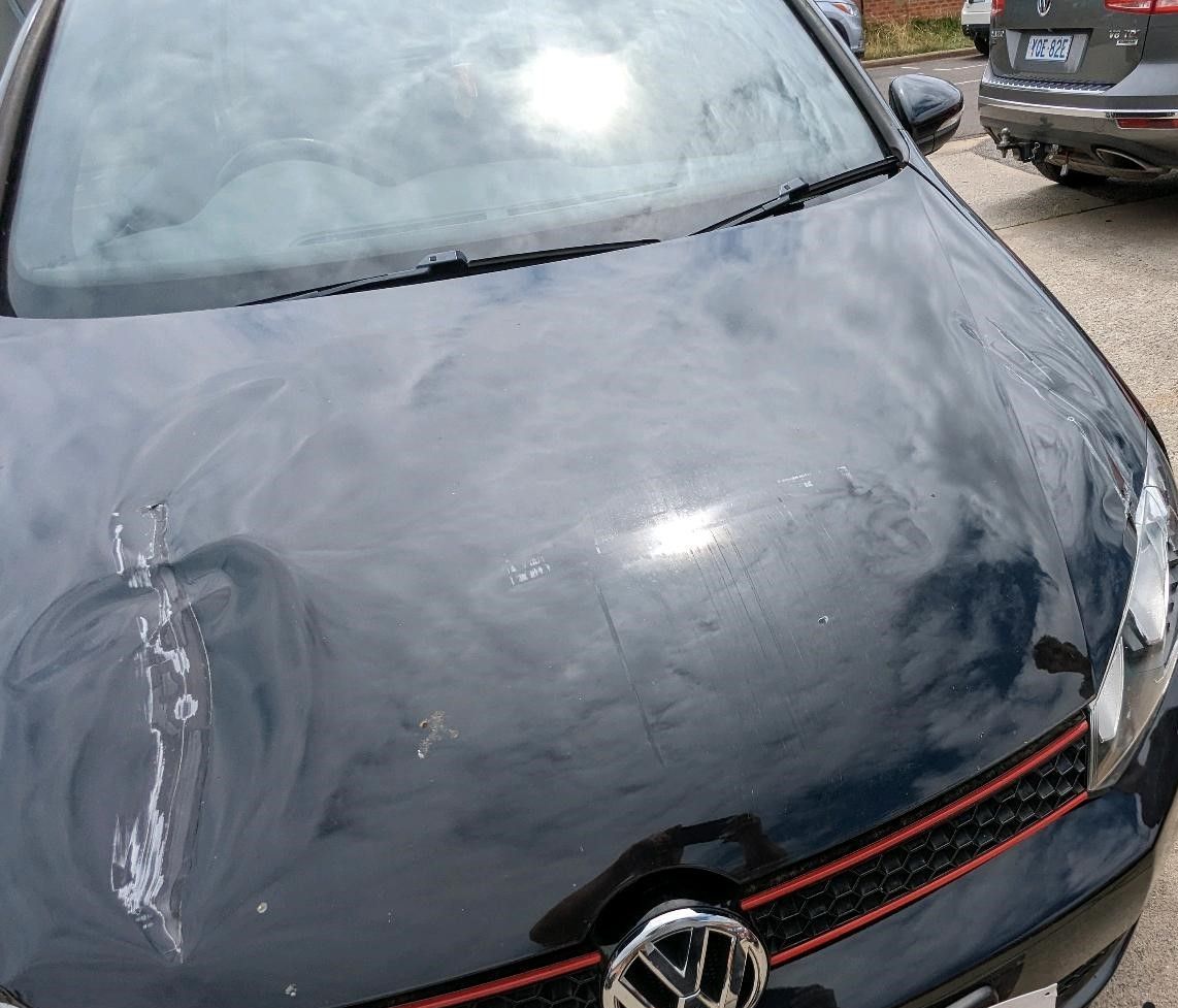 A Car Hood With Visible Dents and Streaks — Moto Bodyworks in Fyshwick, ACT