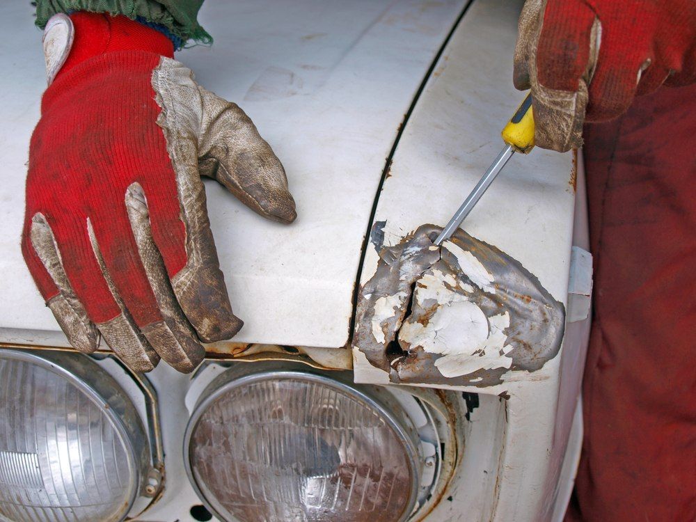 A Person Wearing Gloves is Working on This Car — Moto Bodyworks in Fyshwick, ACT