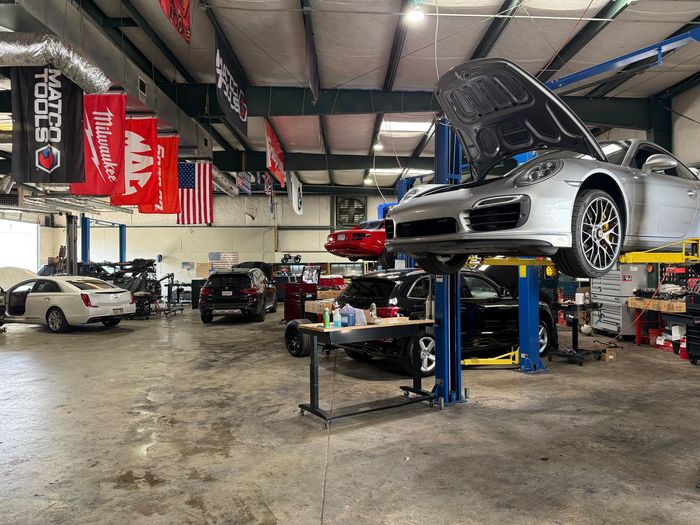 Multiple Vehicles Inside Professional Auto Repair Shop Bay | UAC