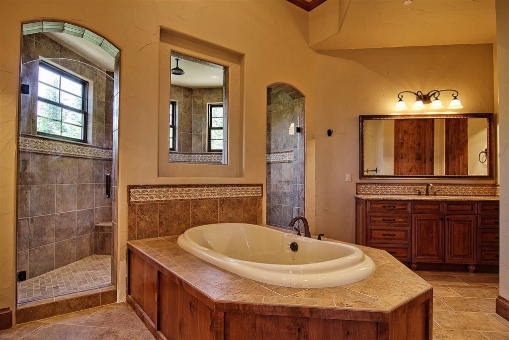 A bathroom with a large tub and a walk in shower