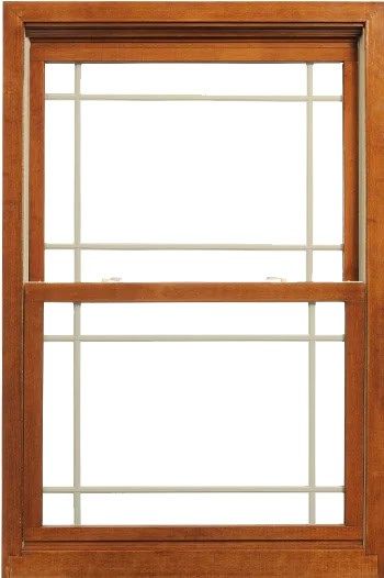 A wooden, single-hung window with a prairie-style grid pattern, featuring an upper and lower sash in a light brown finish.