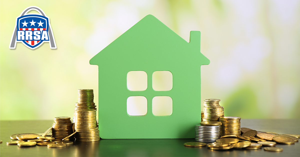 Green house cutout with stacks of coins.