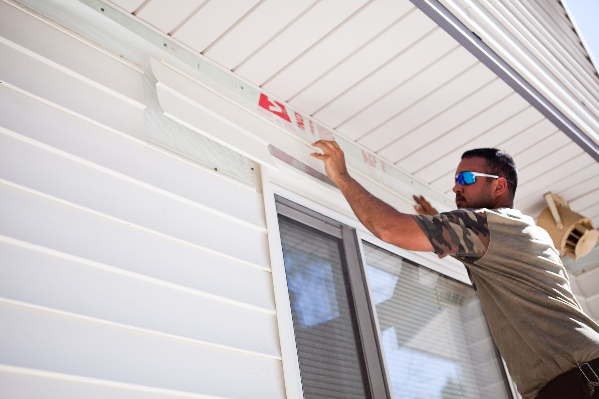 Worker installing siding