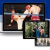 A boxing match is being shown on a laptop and a tablet.