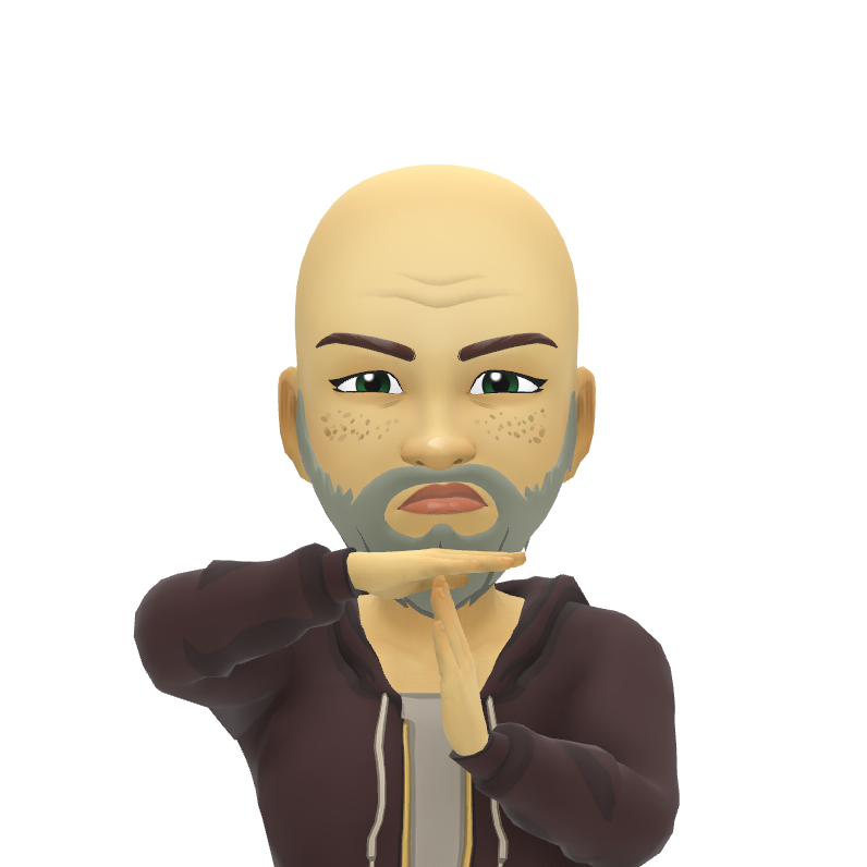 A bald man with a beard is making a hand gesture