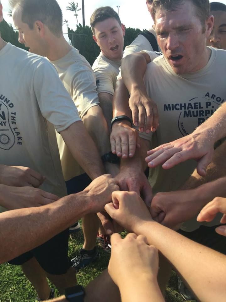 Two men are running in a race and one has the number 03 on his shirt