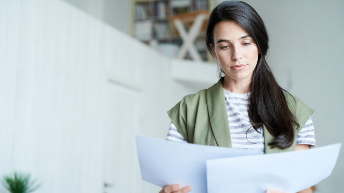 A lady homeowner reading a mold remediation protocol.