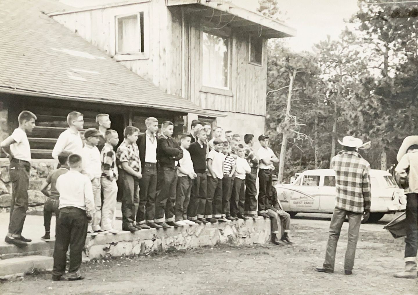 Black and white image of young boys standing on Buckhorn Lodge deck.