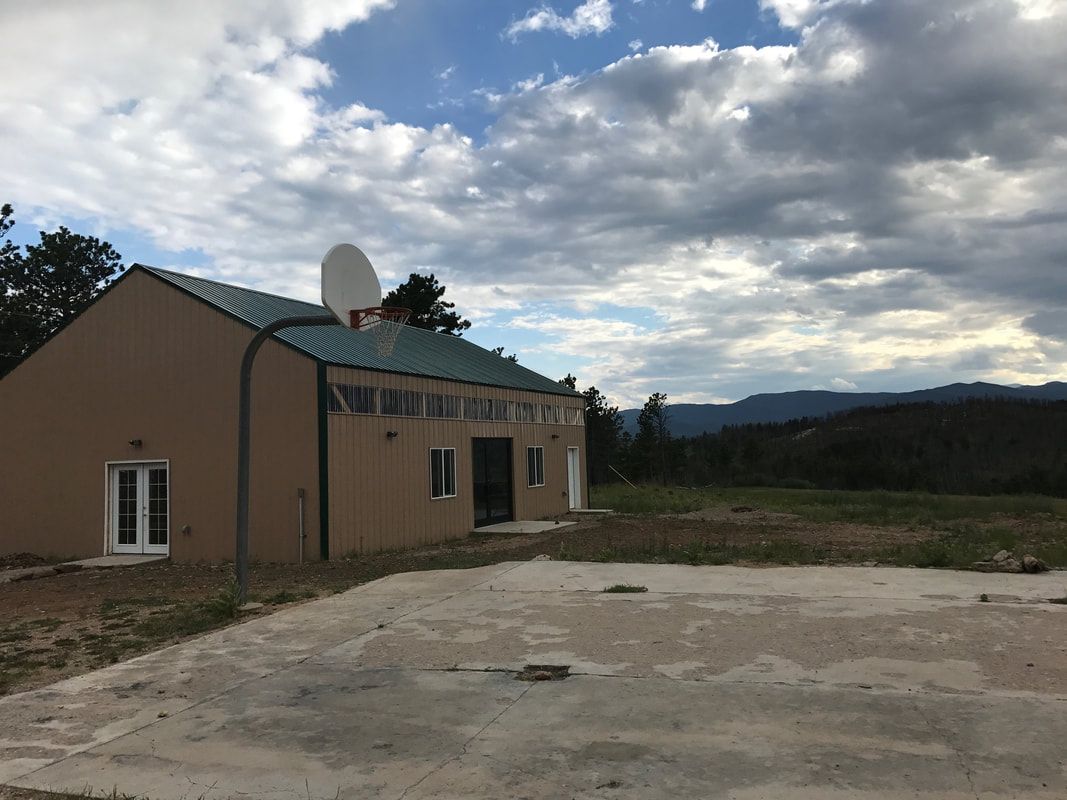 Outside view of Bear Paw Barn and basketball court