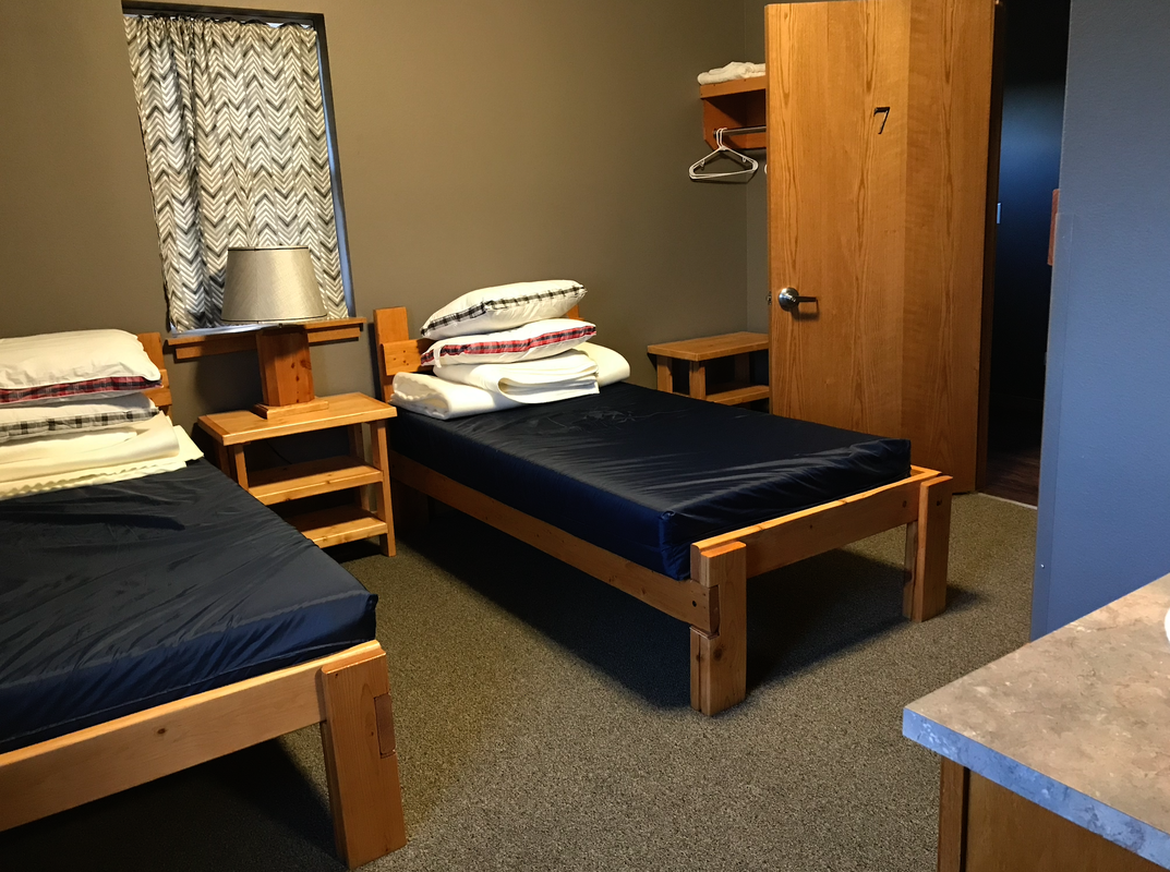 Camp beds with linens in Retreat Lodge.