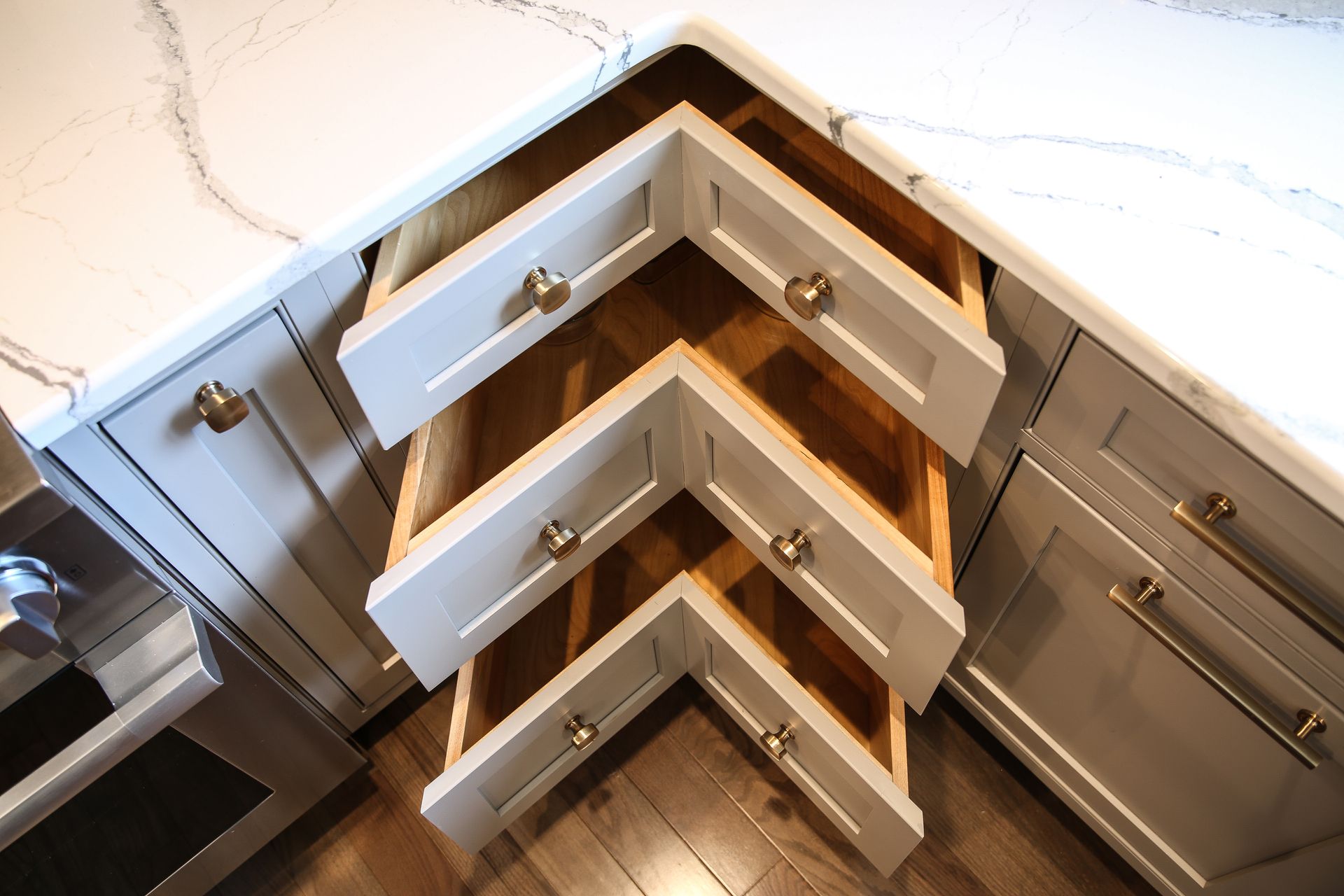 Corner kitchen cabinets with pull-out storage shelves extended open.