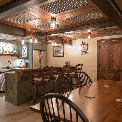 Cozy rustic dining room with wooden table, chairs, and warm pendant lights