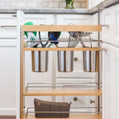 Kitchen cabinet organizer with hanging utensil cups, cooking tools, and a lower basket drawer