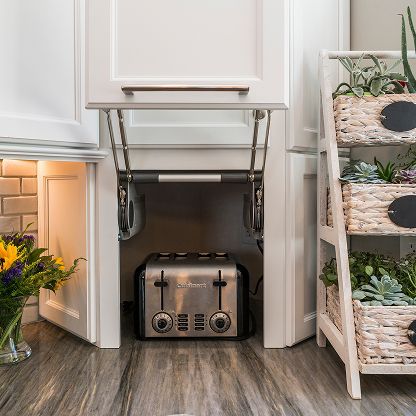 Compact kitchen appliance cabinet with a pull-down mixer lift, beige appliance, and woven plant shelves
