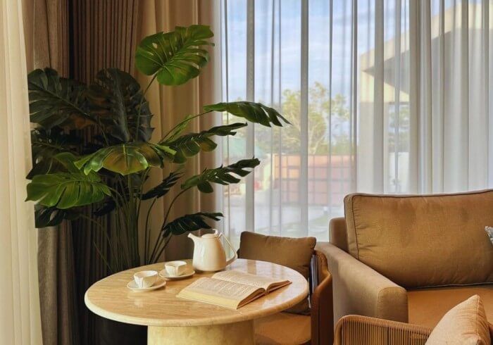 There is a table with a book on it in the living room.